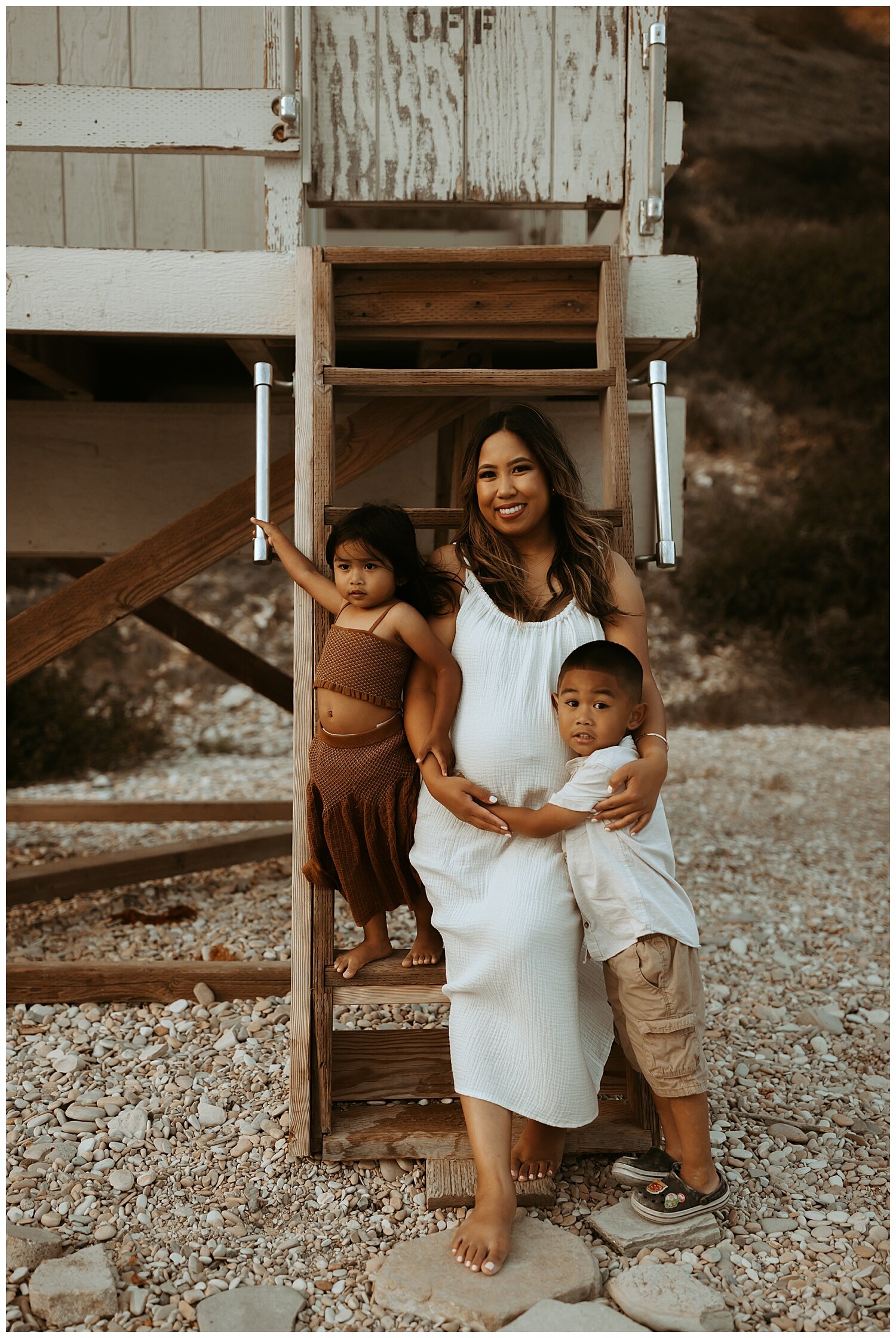 mother with first two babies during maternity photo shoot